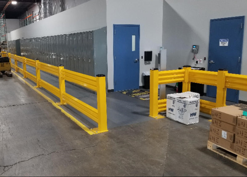 Warehouse interior with yellow safety barriers, boxes, and a forklift.