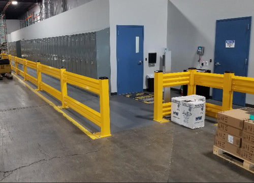 Warehouse interior with yellow safety barriers, boxes, and a forklift.